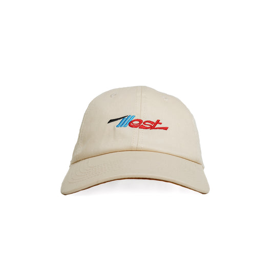 Beige dad cap with embroidered "Ilest" logo in blue, black, and red on the front, featuring a curved brim and adjustable strap.