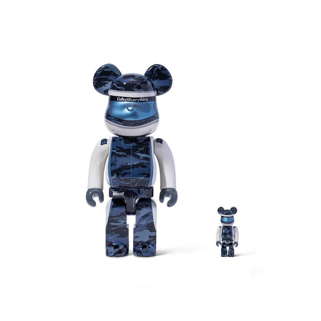 Two BE@RBRICK figures with blue camouflage patterns, one large and one small, featuring white and black accents and collectible branding.