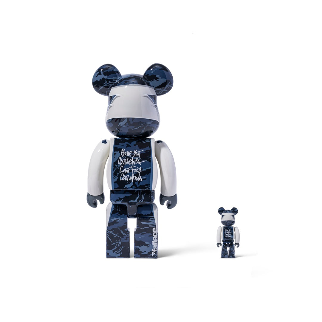 Two Bearbrick figures in a blue camouflage design, one large 400% and one small 100%, featuring black and white accents.