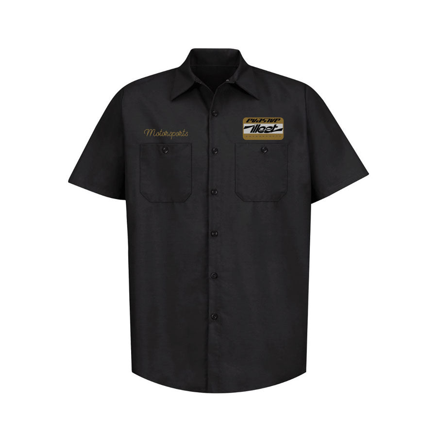 Black mechanic shirt featuring embroidered "Motorsports" text, two chest pockets, and a large Illest x Evasive Motorsport patch on the right chest.