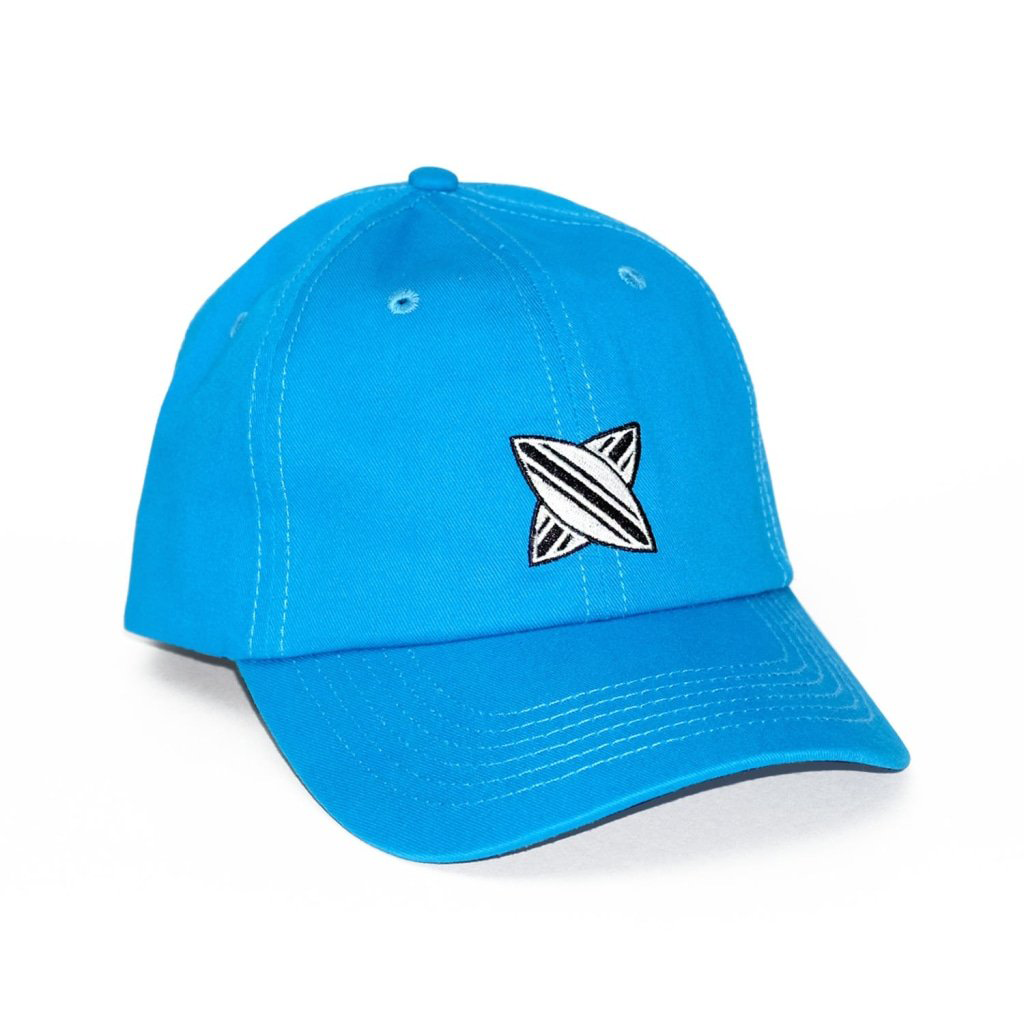 Blue dad cap with a white and black embroidered crossboard logo on the front panel.