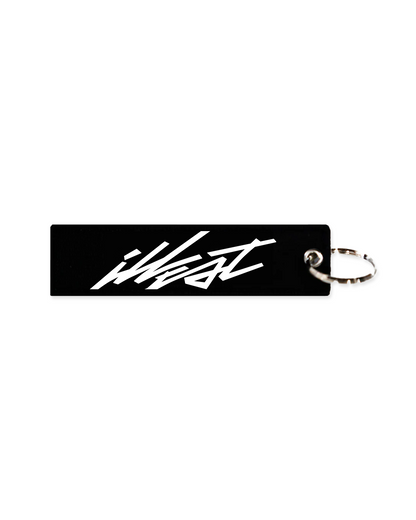 Illest Rough-World Flight Tag Keychain with black rectangular tag and white stylized logo, attached to a silver keyring.
