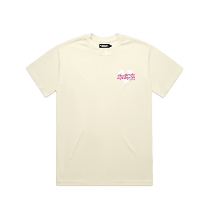 Cream-colored T-shirt with a small pink and white graphic on the left chest that reads "Love is the Hardest Game to Play" in stylized font.