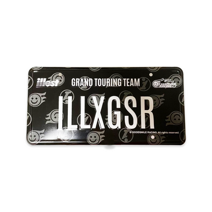 Black vanity plate with white text reading ILLEXGSR, featuring logos for ILLEST and GOODSMILE RACING, with a smiley face design.