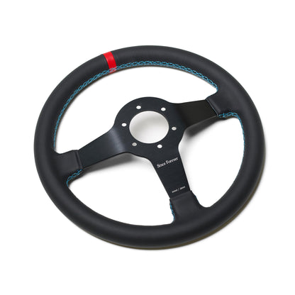 Black steering wheel with blue stitching and a red accent, featuring a metal center with "Since Forever" branding.