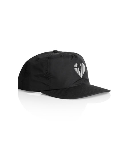 Black cap with a broken heart logo featuring a lightning bolt, designed by Heartbreaks Cap brand.