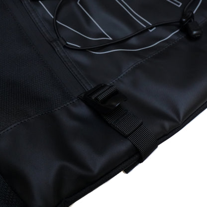 Close-up of a black Illest Travel Tote Bag with durable fabric, adjustable strap, and a front pocket for organization.