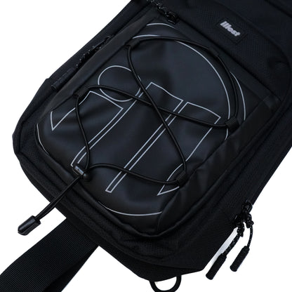Illest Crossbody Bag in black with a white logo, featuring a front zip pocket, adjustable strap, and secure cord lock.