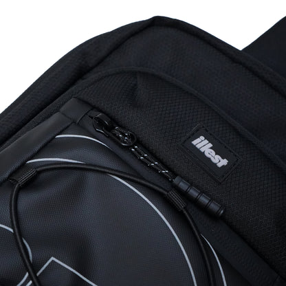 Close-up of a black Illest crossbody bag with a textured fabric, zipper detail, and a visible Illest logo patch.