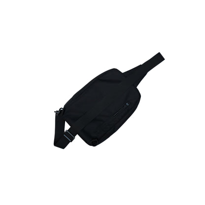 Black Illest Crossbody Bag with adjustable strap, zippered front pocket, and sleek minimalist design.