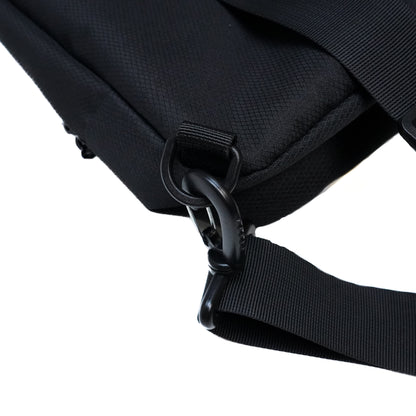 Close-up of a black Illest Crossbody Bag showing a durable strap, metal clip, and textured fabric for stylish, secure carrying.
