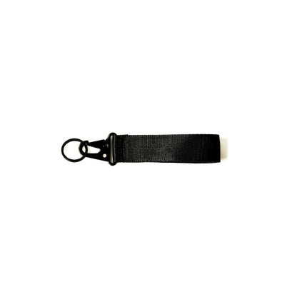 Black fabric keychain with a metal ring and clip, designed for holding keys and accessories.