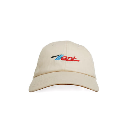 Beige dad cap with embroidered "Ilest" logo in blue, black, and red on the front, featuring a curved brim and adjustable strap.