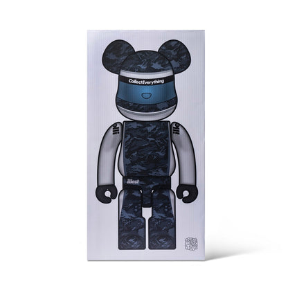 A black camouflage patterned 1000% BE@RBRICK figure with a visor, standing upright on a white background.