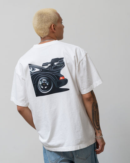 White T-shirt featuring a graphic of a black sports car's rear view with an open trunk, designed by Illest Brand.