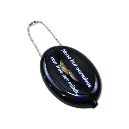 Black rubber squeeze purse with a chain handle and a sliding cover that reads "None but ourselves can free our minds" in white text.
