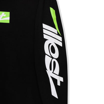 Close-up of a black collegiate long-sleeve tee featuring bold white and green logo graphics on the sleeve.